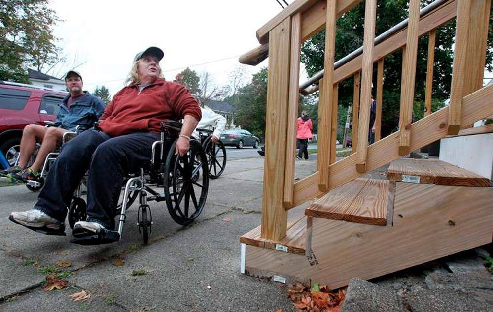 Lancaster Selectman Jean Syria, right, points out a new set of stairs to a Main Street business without a handicap-accessible entrance