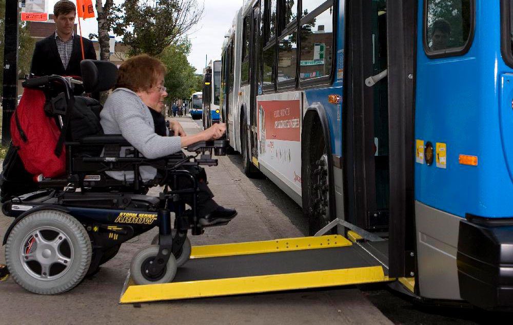 Woman boards a bus with technology to improve wheelchair accessibility, at the Lionel Groulx métro stop in Montreal,