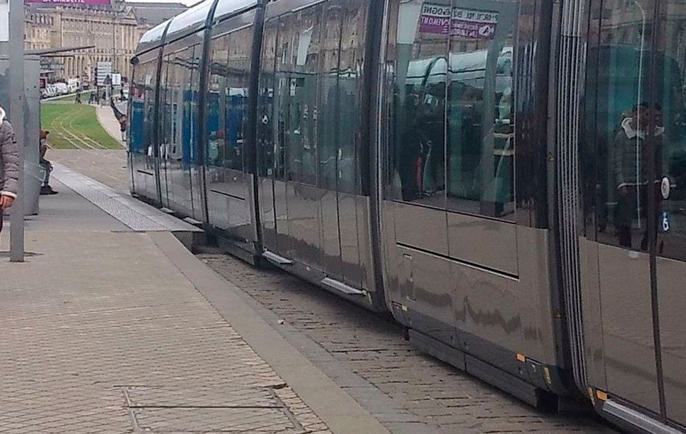 A tram pulling out of the station. As you can just about see, the carriage of the tram is flush against the platform, making entry step free.