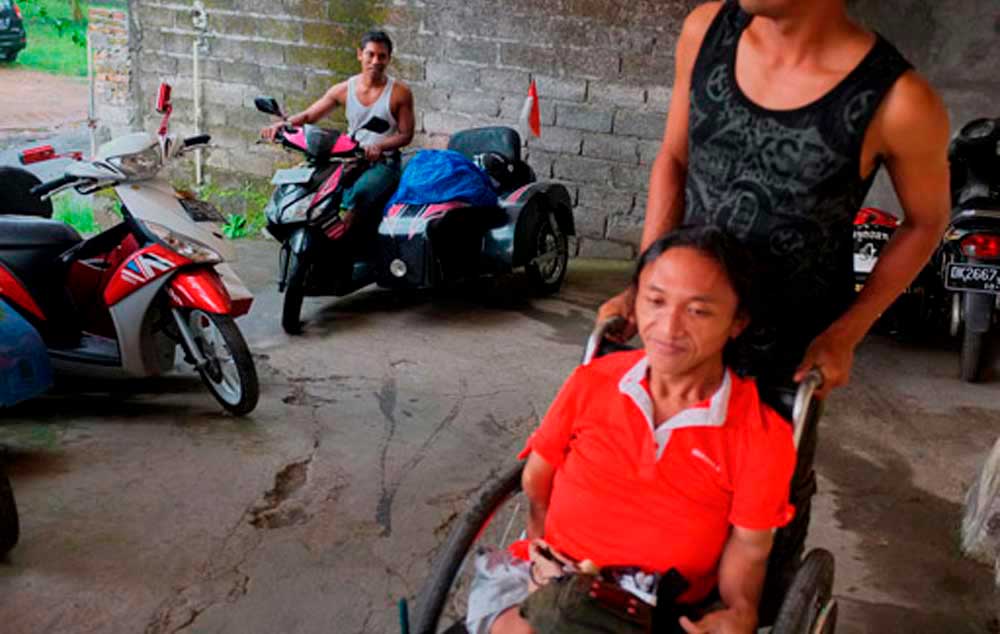 Tour guide: A disabled person, Gusti Lanang, parks the sidecar scooter he uses to take tourists around attractions in Tampaksiring and Ubud. BD/Anggara Mahendra