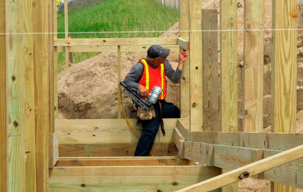 Adam Bartels of Len Small Inc. works on a handicap ramp to the top of the dunes in Kitty Hawk, N.C.