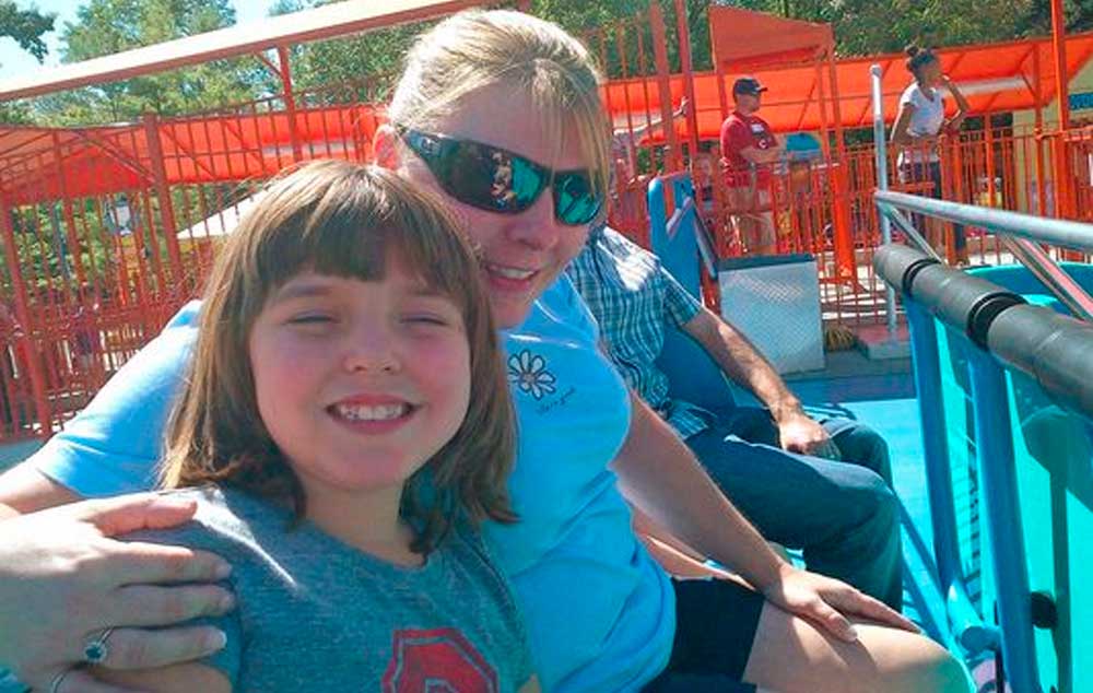 Sherry Yuskewich, right, and daughter Kendall enjoy a ride in 2012 at Kings Island amusement park in Mason, Ohio. The family makes several trips each year to the park, where they say Kendall, who has autism, always had been permitted to ride rides with little wait time.