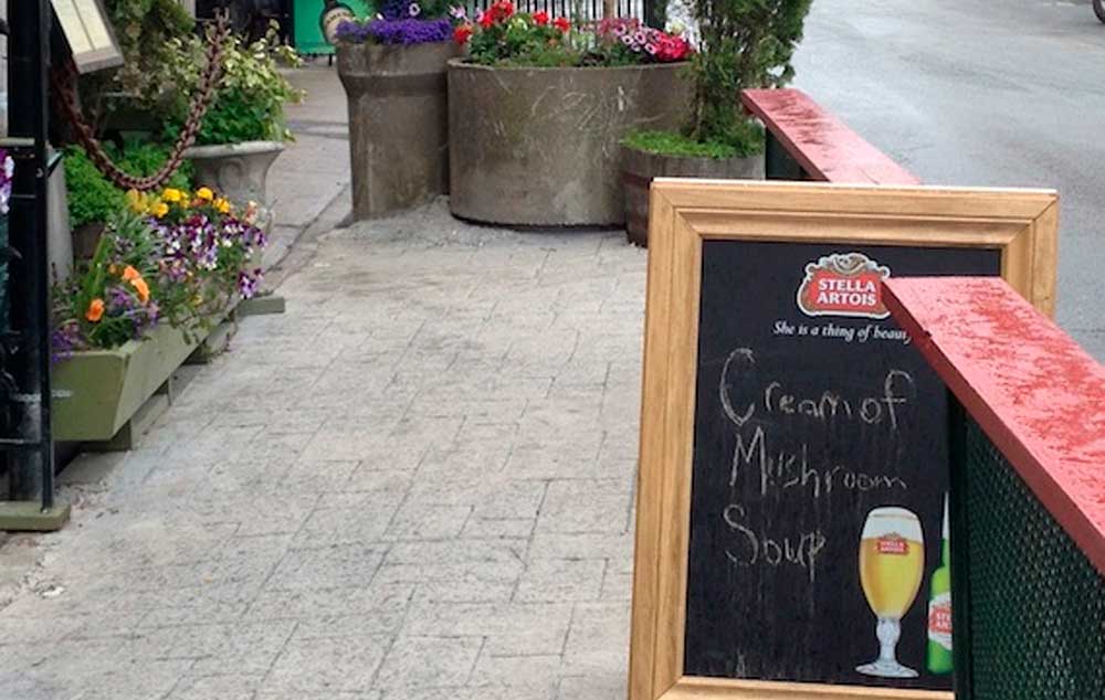 Sidewalk cafes and sandwich boards can present unnavigable obstacles to the visibly impaired.