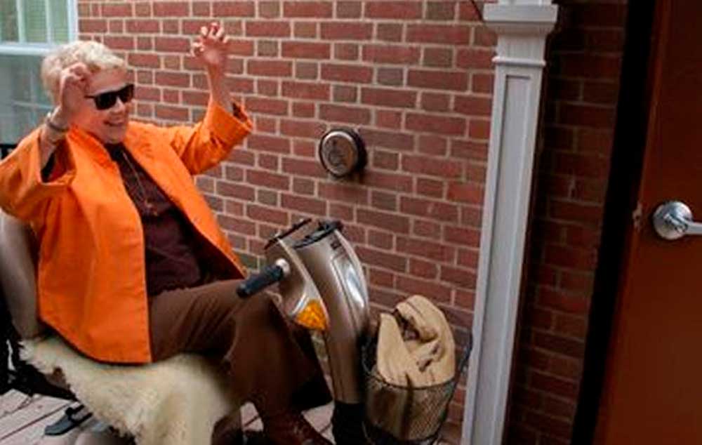 Linda Crabtree raises her arms in joy as the door to RiverBrink Art Museum opens at the push of a button. The Queenston museum recently completed the first phase of its planned accessibility upgrades