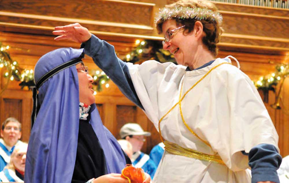 Cindy Wilson of Corvallis portrays Gabriel informing Mary (Amy Chapman of Corvallis) of her pregnancy during rehearsal for the Christmas pageant at the First Presbyterian Church of Corvallis.