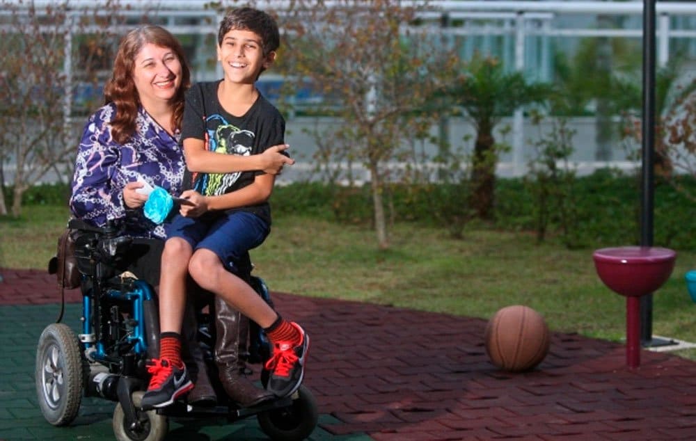 Margarida e o filho Raphael, que sempre adorou a carona na cadeira de rodas