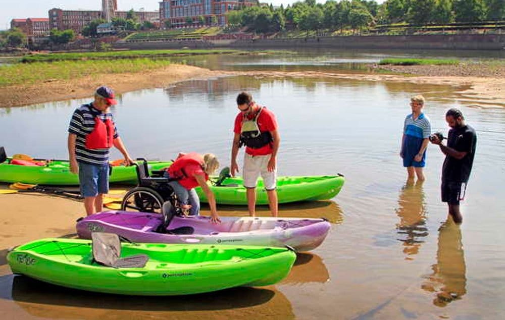 Kristine Groenenboom, her husband and river guide of Outside World Outfitters as they prepare to launch their kayaks for a float down the River.