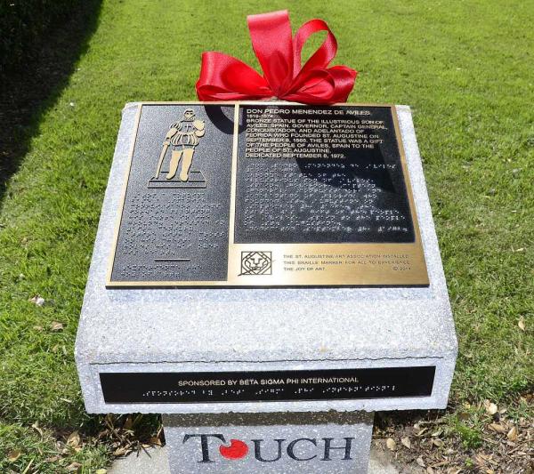 A new marker in front of the Lightner Building in St. Augustine gives a description of the statue in English and in Braille.