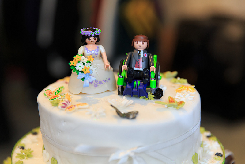 The wedding cake ornament, with characterized dolls, showed the groom Tim in his wheelchair