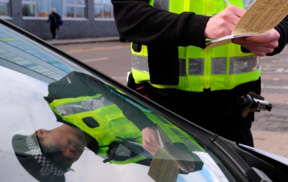 Pc Daniel Halliday tickets a motorist parked in a disabled parking bay at the Lasswade Centre.