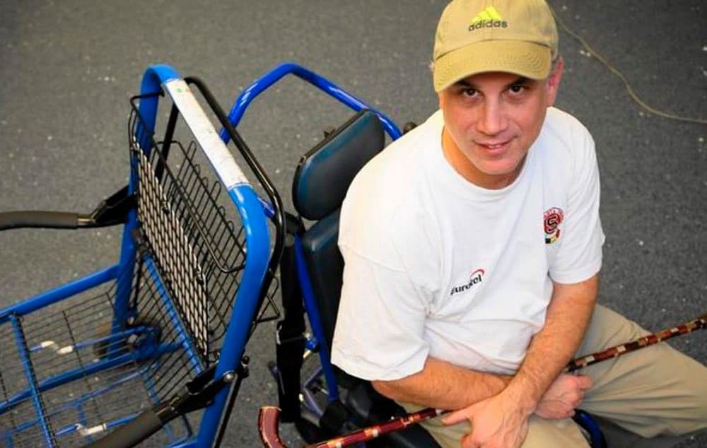 Eric Lipp sits in an aisle chair, a wheelchair used aboard airplanes, in the organization's offices in Chicago. The seat at left is used inside airports.