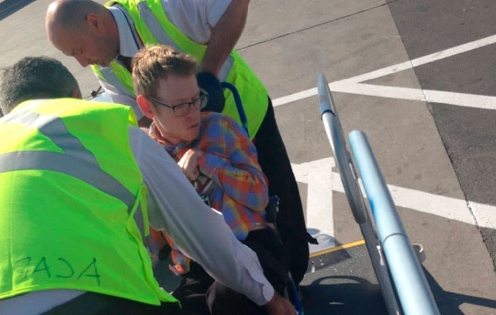 Tim Rose is assisted while boarding an Air Canada flight. The airline now says it cannot accommodate his wheelchair.