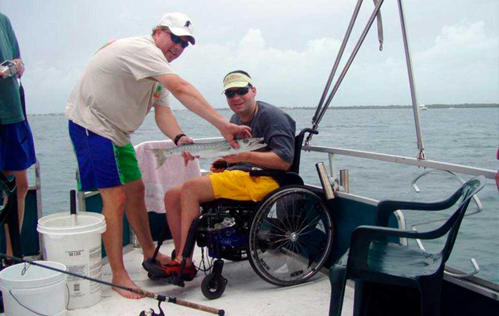 Special to the Times Capt. Mick Nealey enjoying a day of fishing with one of his physically challenged customers.